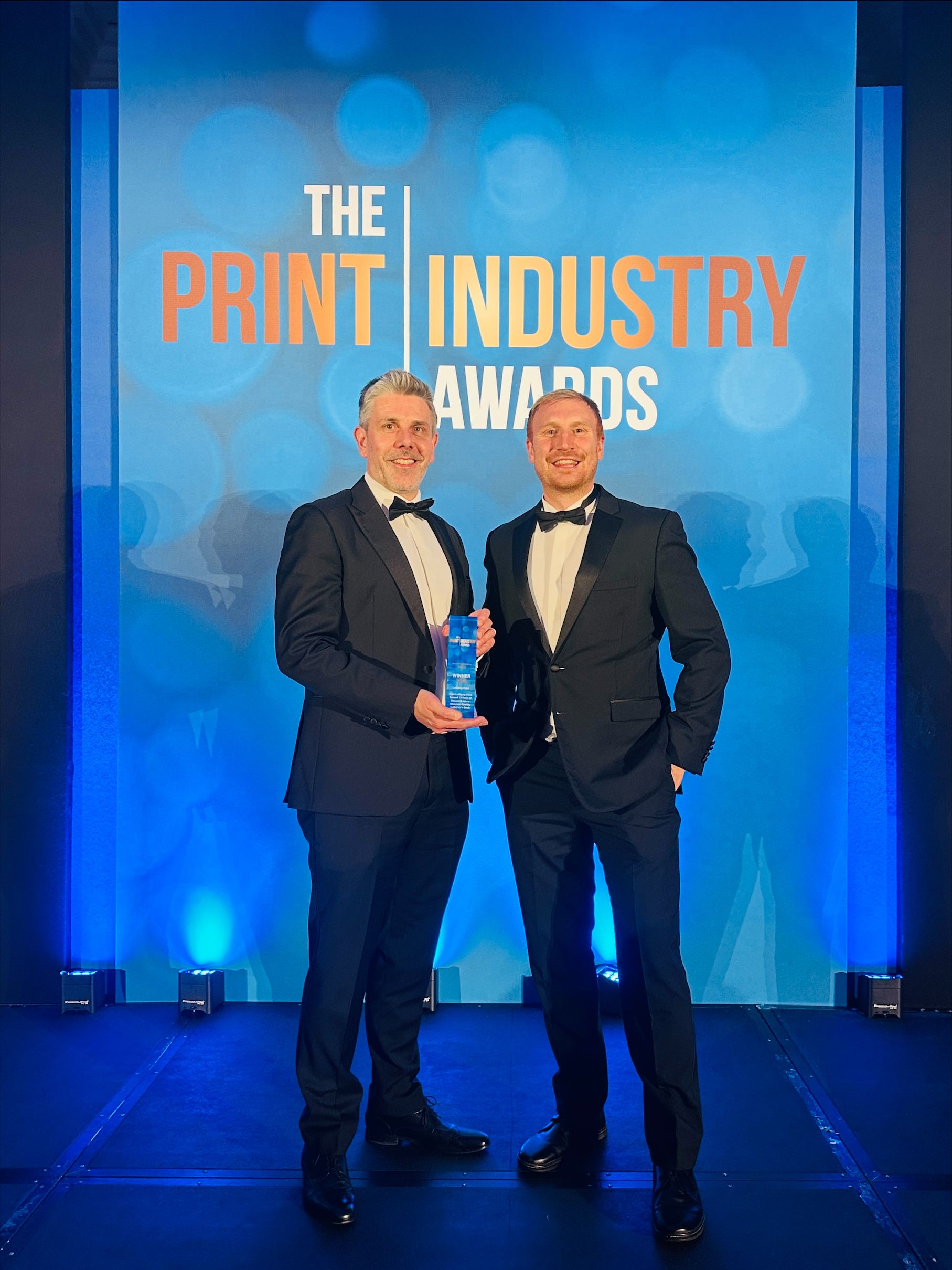 Lollipop Print Brand Manager, Dan Patience (left) and Director, Ed Entecott (right) collect their award.